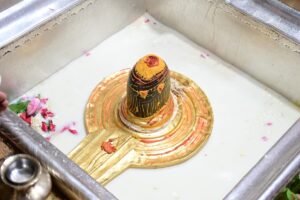 सोमवार व्रत के लाभ दर्शाती एक भक्त की छवि, जो भगवान शिव को जल अर्पित कर रहा है